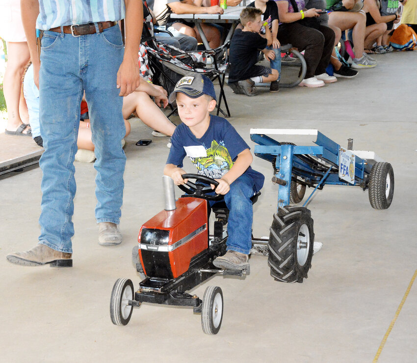 Levi May focuses on the ultimate goal of a full pull during children&rsquo;s pedal pull held on the third day of the 76th Gasconade County Fair in the four-year-old division.