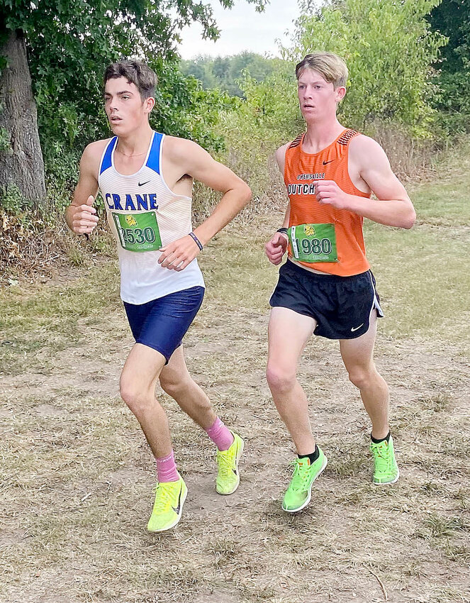 Zach Holtmeyer (right) races alongside Crane&rsquo;s Calen Faucett during the varsity boys gold division race Saturday at the Missouri Southern Stampede in Joplin.