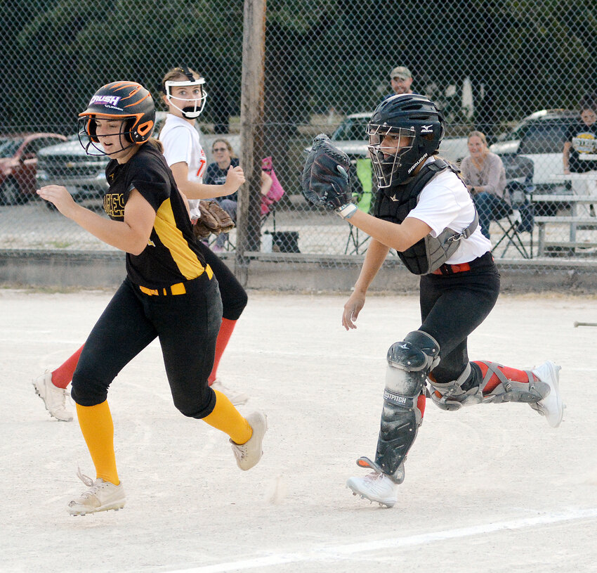 Natalie Gehlert (right) runs down Vienna&rsquo;s Eva Hollis during round one of Maries County softball action last Thursday at Belle City Park in which the visiting Lady Eagles won 10-2.