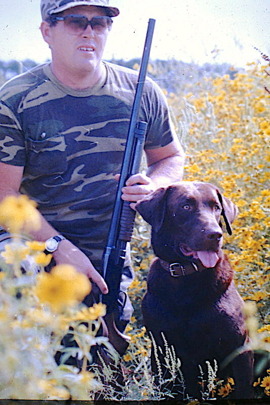 A younger Larry Dablemont is pictured hunting with his labrador.