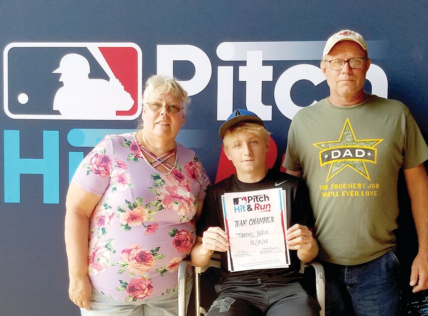 Tanner Huhn, 14, of Westphalia, will battle for the national MLB Pitch, Hit &amp;  Run competition during the World Series. He is shown with his parents, Lori and Kenny, after winning the contest at Busch Stadium on Aug. 19.