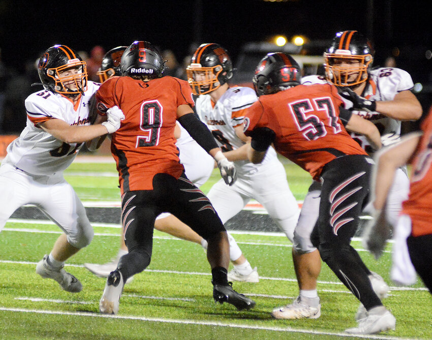 Cody Perkins (far left) and Hayden Shoemaker (above, far right) provide blocking for Dutchmen senior quarterback Blake Elliott during Owensville&rsquo;s 38-35 victory Friday night spoiling Union&rsquo;s &lsquo;Barbie&rsquo; dream homecoming.