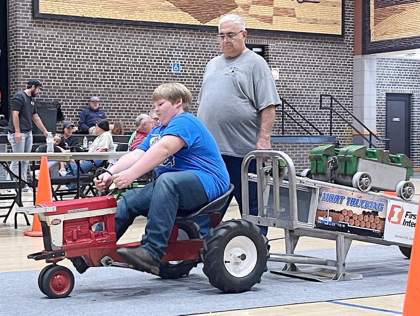 Eli Wax pulls his way down the track before winning a national championship in the 10-year-old boys division of the National Pedal (Tractor) Pull held Saturday, Sept. 23 at The Corn Palace in Mitchell, S.D. Wax was among nine area national qualifiers that competed in South Dakota.