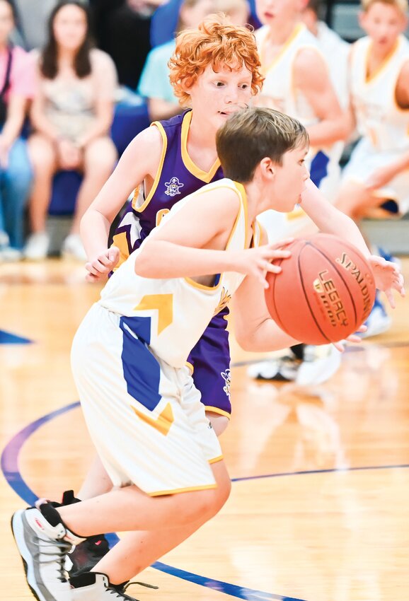 Raylan Kolb of Fatima works to get around Colten Miller of Chamois in Friday&rsquo;s JH game at Westphalia.