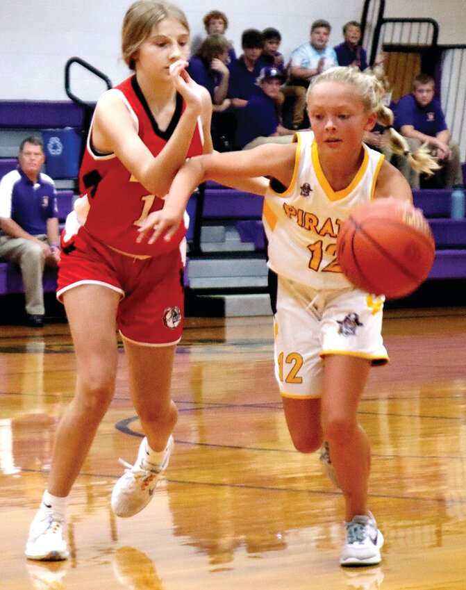 Carly Schollmeyer of Chamois pushes the ball up the floor during a JH game against Dixon.