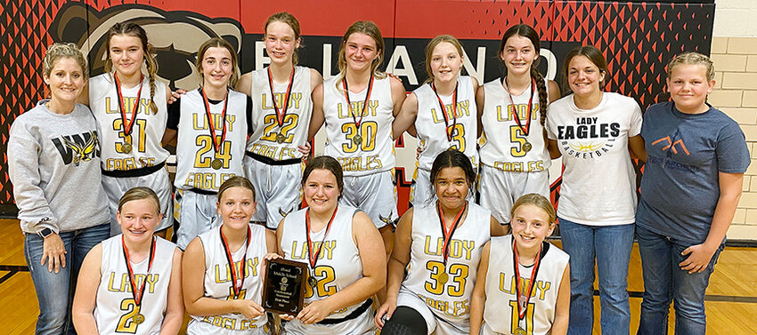 VMS&rsquo; LADY Eagles celebrate their Bland Lady Bear Basketball Tournament title by having a team picture taken with the championship plaque following their 26-24 come-from-behind victory over Salem&rsquo;s Lady Tigers in Friday&rsquo;s night championship game at Bland Middle School.