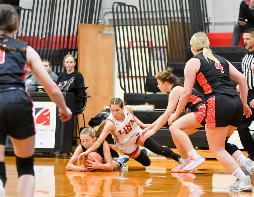 Natalie Gehlert (center) gains possession of a loose basketball for Belle&rsquo;s Lady Tigers during their consolation championship showdown with Linn&rsquo;s Lady Wildcats Friday at the Eugene Girls Basketball Tournament in Cole County.