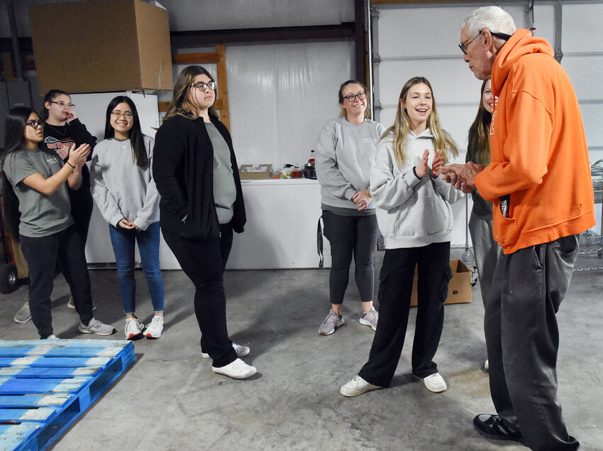 Andrew Michel, a planner with the Operation Christmas program, applauds Owensville High School FCCLA members Arianna Baguio, Olivia Crull, Sophia Gregor, Kiana Wehmeyer, Hannah Fletcher, Allie Kuebler, and Olivia Beste after they had completed boxing day packing for the 2023 campaign on Dec. 13. They helped prepare food boxes for 175 area families including140 children, and 361 adults.