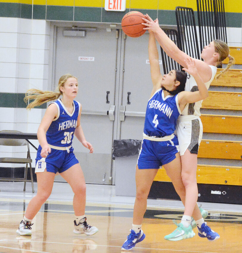 Kimber hale (center) goes up to deflect the basketball back towards Hermann Lady Bearcat teammate Kennedie Witthaus during Rumble on the River Shootout action Saturday afternoon in Quincy, Ill., against West Central&rsquo;s Lady Cougars. Hermann will enter the 2024 portion of their season with a 7-2 record
