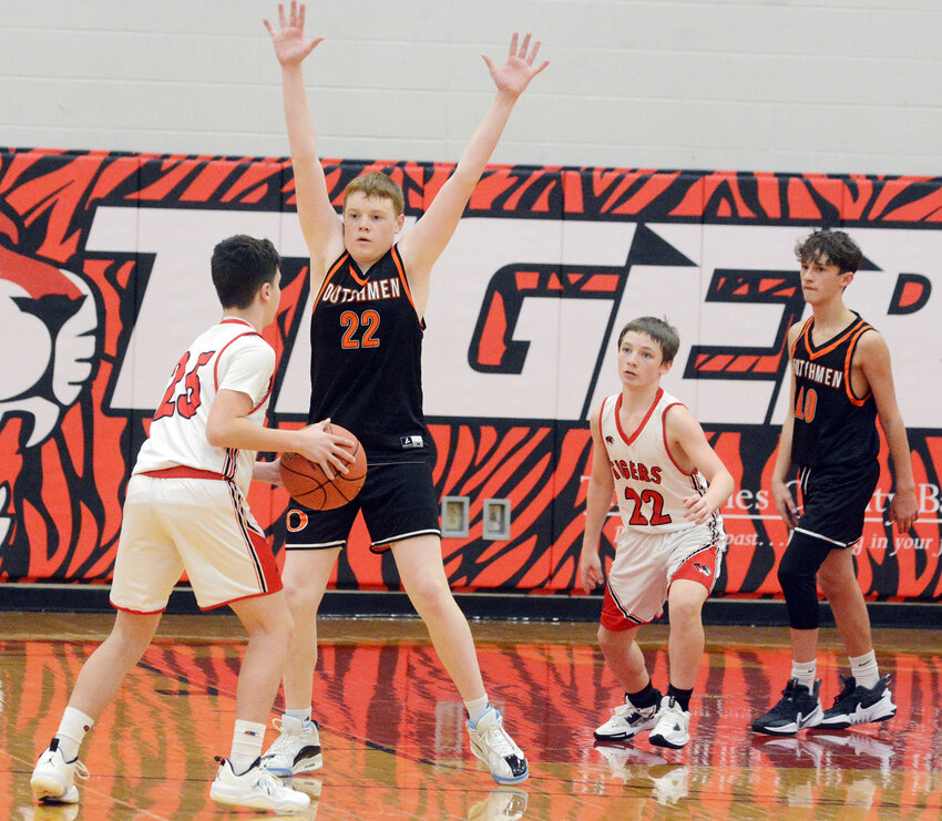 Tyler menz (second from left) gets his hands up on defense for Owensville&rsquo;s eighth-grade Dutchmen last Wednesday afternoon in daytime doubleheader hoops action at St. James.