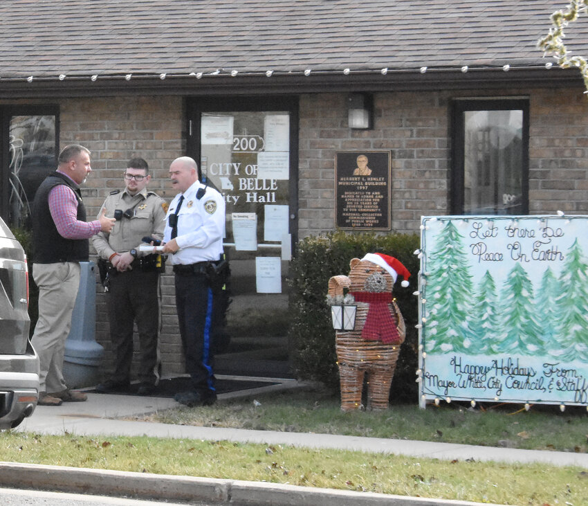 MARIES COUNTY Sheriff Chris Heitman speaks Dec. 20 outside Belle City Hall with City Marshal Jerry Coburn (in white) as interviews were being conducted with city staff. Heitman&rsquo;s deputies served search warrants at the maintenance shed across the street and in the City Hall building.