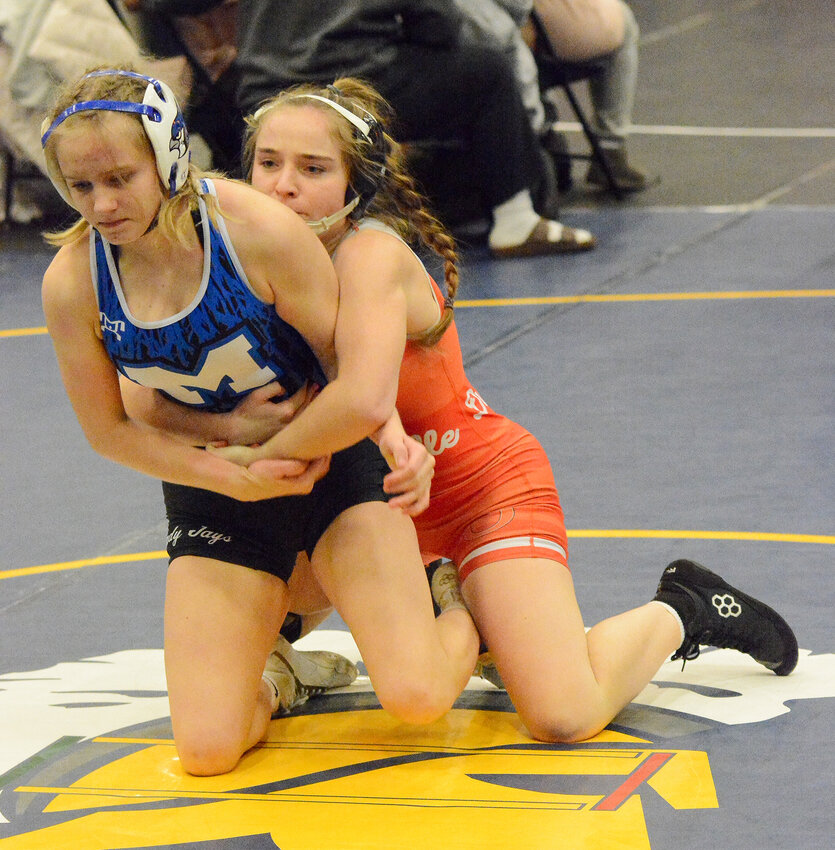 Jenna Vandegriffe (left) works to keep Marshfield’s Graclyn Hursh down on the mat during their third-round consolation match at 115 pounds at the Wonder Woman Varsity Wrestling Tournament in Columbia.