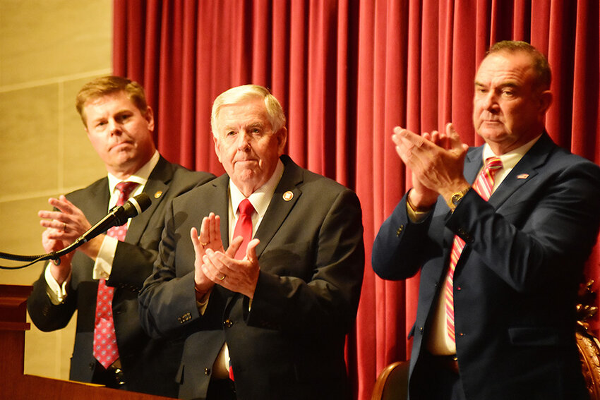 HOUSE SPEAKER Dean Plocher, Gov. Mike Parson, and Lt. Gov. Mike Kehoe applaud Jan. 17 (from left) as guests are introduced in the House prior to Parson&rsquo;s final State of the State address.