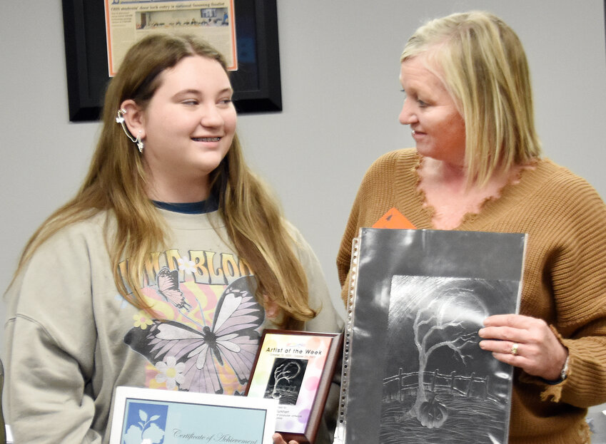 TERESA SCHULTE visits in November with Owensville Middle School student Ashlee Burkhart after presenting her with recognition for her artwork.