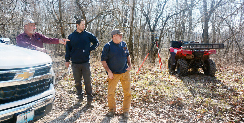 Eastern District Commissioner Doug Drewel (left) points to one end of the gravel hammerhead at Fish Hollow on Feb. 20 while T.C. James with Show-Me Land Surveying and Presiding Commissioner Victor Stratman look on. The group went to the Gasconade River access to complete a court-ordered survey.
