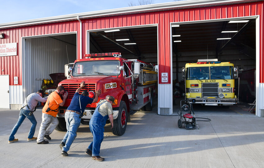 For good luck, Bland firemen hand-push their new-to-them pumper/tanker into the firehouse for the first time. The 1991 International fire truck was loaded up with extra surprise donations to the Bland Fire Protection District by the Hebron Fire Department in New York.