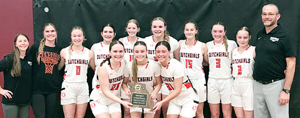 Owensville Dutchgirl basketball team members celebrate their first district title since 2016 with a team photo following their 55-40 victory over School of the Osage Friday night at Eldon High School during the MSHSAA Class 4, District 10 Girls Tournament title game.