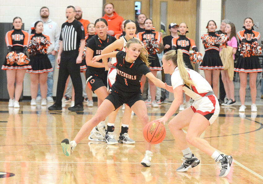 Anya Binkhoelter (center) stares intently at Aurora’s Jaelyn Ernest during quarterfinal action Friday night.
