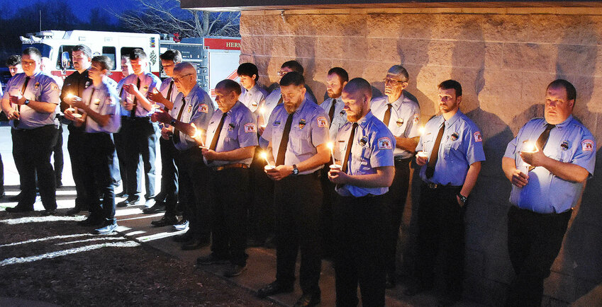 Hermann Fire Department personnel participate March 12 in a candlelight ceremony to close a memorial vigil at Hermann&rsquo;s Riverfront Park for Det. Sgt. Mason Griffith and in honor of seriously wounded patrolman Adam Sullentrup. Approximately 300 area residents attended the program.