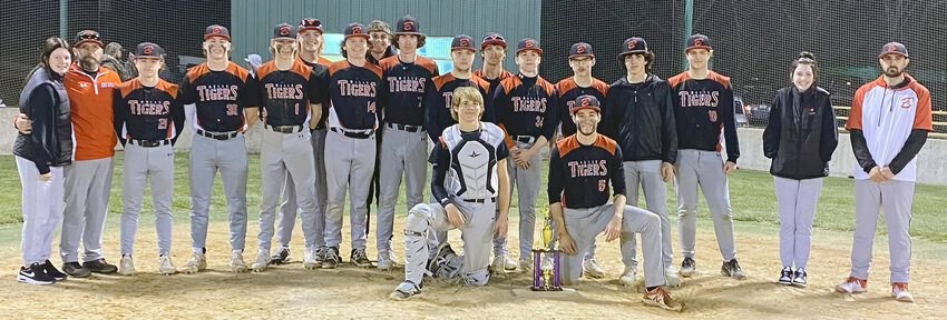 Belle Tiger baseball team members (above) celebrate their Stoutland Tournament title with a team-hardware picture following their 3-0 title game shutout of Dixon last Thursday night.