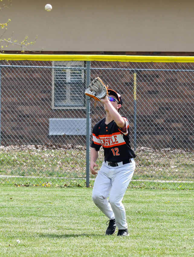 Landon Ely camps out under a fly ball in left field for Owensville&rsquo;s Dutchmen during Easter weekend baseball action at Vienna.