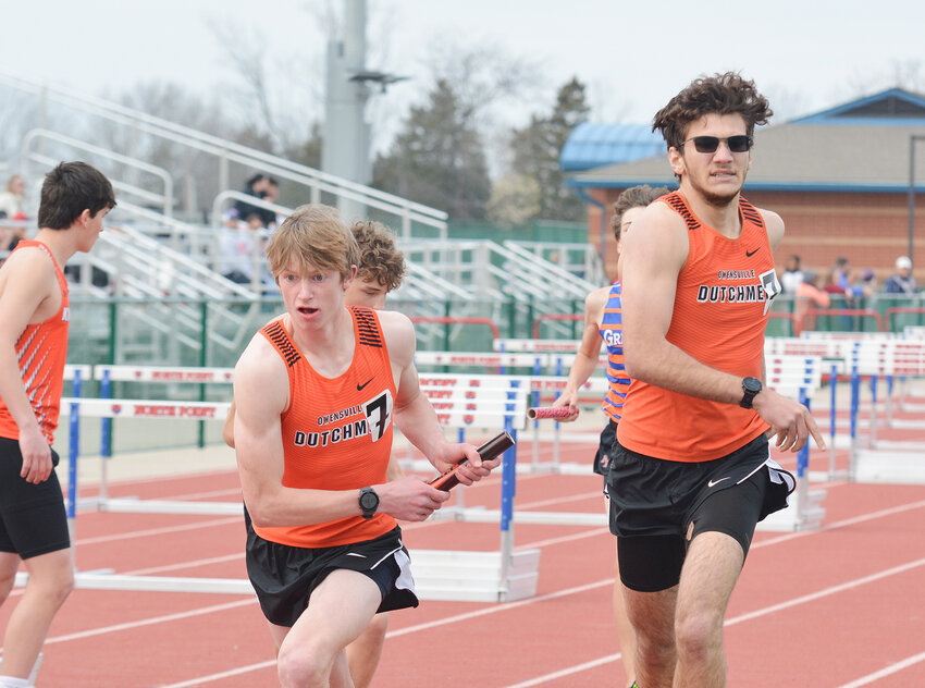 Zach Holtmeyer (center) secures the baton from Felix Guerrero during the boys 4x800-meter relay in a recent track meet at North Point High School in Wentzville.
