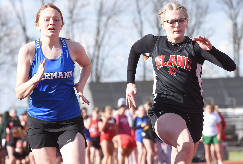 Chloe Jones (far right) sprints down the track in the girls 100-meter dash for Bland&rsquo;s Lady Bears.