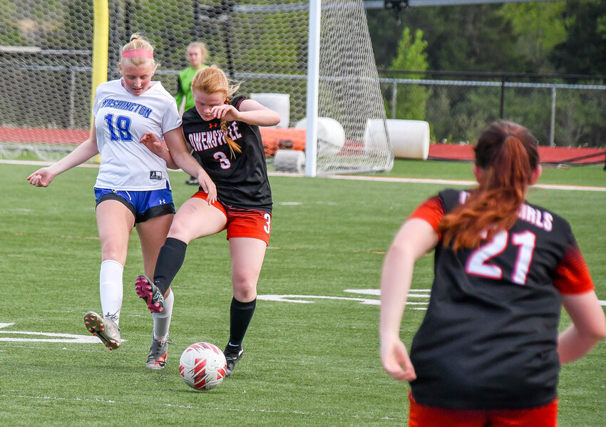 Elizabeth Adams (center) battles a Washington Lady Blue Jay defender during recent home girls soccer action at Dutchmen Field for Owensville&rsquo;s Dutchgirls. OHS is scheduled to host St. James today (Wednesday) and Sullivan tomorrow (Thursday) in home tournament action at 5 p.m., both nights.