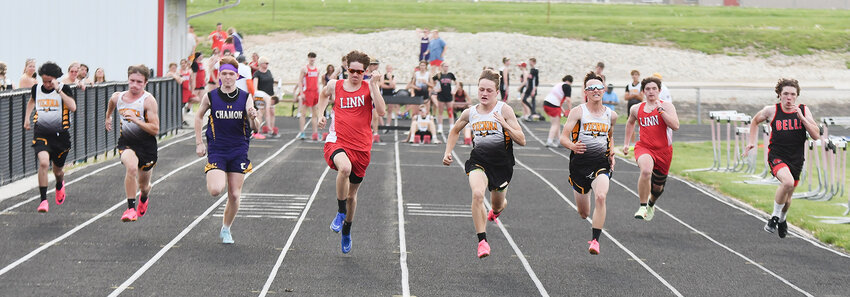 Maries County athletes are pictured competing during the Maries-Osage Challenge track meet held last Monday inside the Linn High School Athletic Complex. Events highlighted include the varsity boys 100-meter dash (above) in addition to the varsity girls 4x100m relay, the varsity boys shot put and the middle school boys 4x800m relay.
