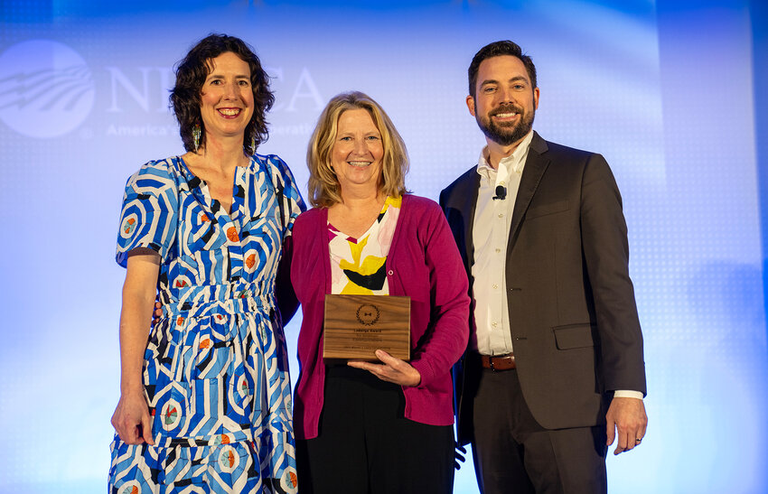 Crawford Electric’s Laura Hengstenberg (center) accepts the 2024 LaBerge Award from NRECA’s Holly Wetzel (left) and the Council of Rural Electric Communicators’ Scott Gates at the 2024 Connect Conference in Baltimore.