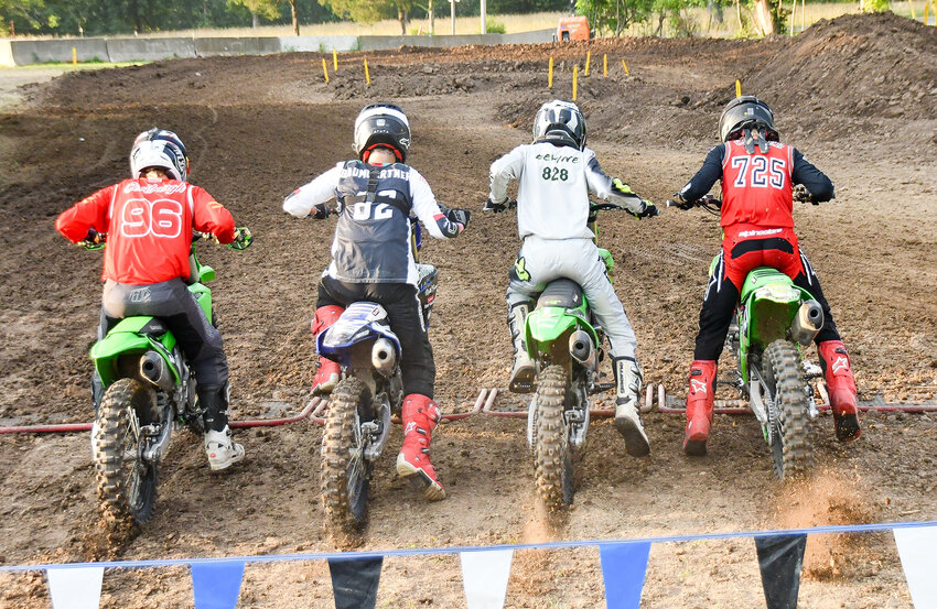 Tanner Devine (third from left) takes off during the start of the main race of the 250 Novice Division during motocross action on the opening night of the 76th Belle Fair last Wednesday night.