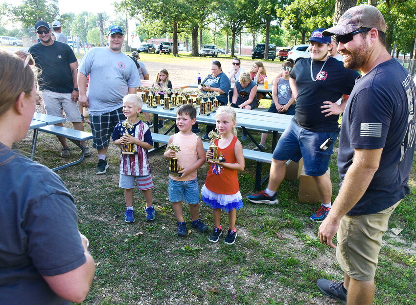 Elias Hempelmann ( far left), Tucker Grellner and Abbi Meyer stand for a group picture after they finished in the top three of the four-year-old division in the children’s pedal tractor pull during Friday’s community picnic put on by the Owensville Volunteer Fire Department (OVFD).