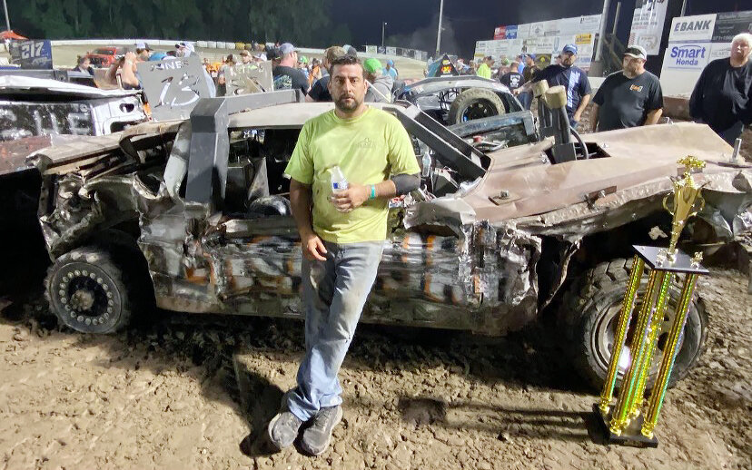 Vienna resident Tyler Jones poses with the trophy he won on June 1 at the Border Wars Light Weld Class Demolition Derby in Adel, Iowa. Jones was one of 18 drivers on Missouri’s team in the competition, which brought contenders from Iowa’s neighboring states.