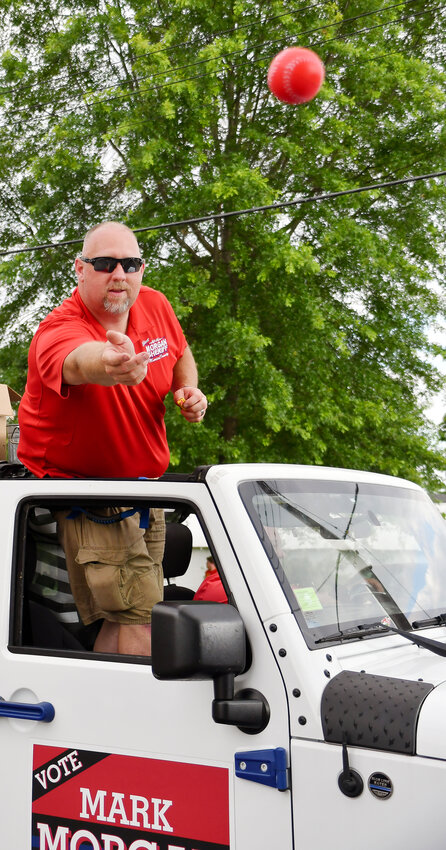 Mark Morgan throws out a ball during the Belle Fair parade.