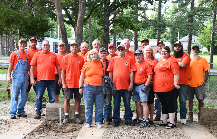 Founding Members of the newly formed Luster-Owens Owensville Horseshoe Pitching Club gather for a group photo inside the horseshoe pits at Owensville&rsquo;s Memorial Park.