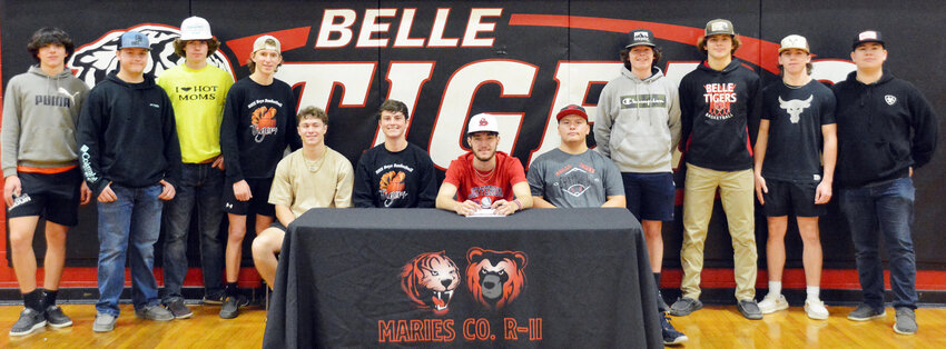 Clayton Shockley (seated in center) signs his letter of intent to continue his college baseball career at Jefferson College in Hillsboro surrounded by his former Belle High School Tiger baseball teammates.