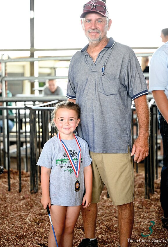 Sadie Kempker is all smiles after winning the “Pee Wee” event at the Osage County Fair. She is shown with her grandfather, Fair Swine Superintendent Roger Scheulen.