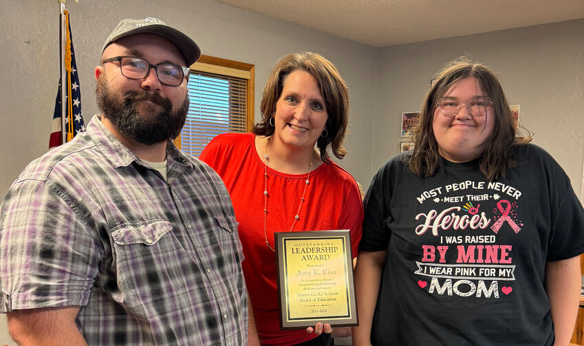 Maries R-2 Board of Education President Kenda Sanders on Aug. 27 presented a post-humus service award to two of former board member Amy Kiso’s children who were present, Garrett and Alaina Bledsoe. Kiso’s sister Lorie Kiso was also present. Braxton and Zach Bledsoe, Kiso’s older children, were unable to attend.