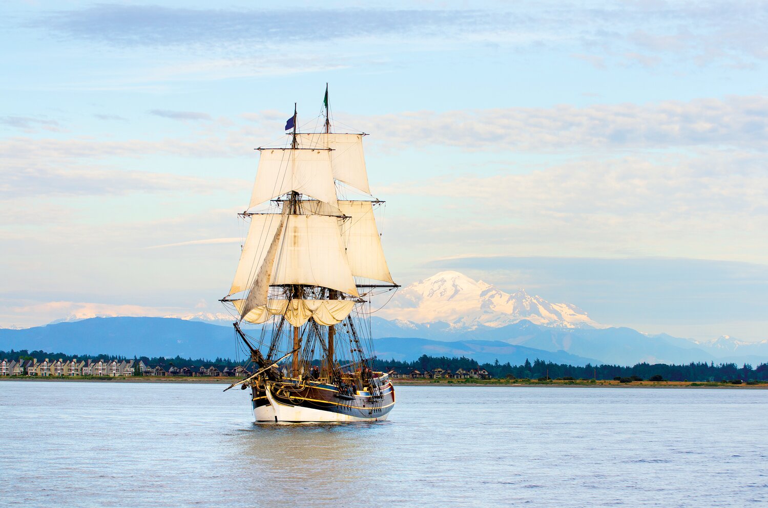 Lady Washington at sail in Semiahmoo Bay, Washington. Mount Baker is in the distance. A historic replica of the original 18th Century brig. Owned and operated by the Grays Harbor Historical Seaport, Aberdeen, Washington